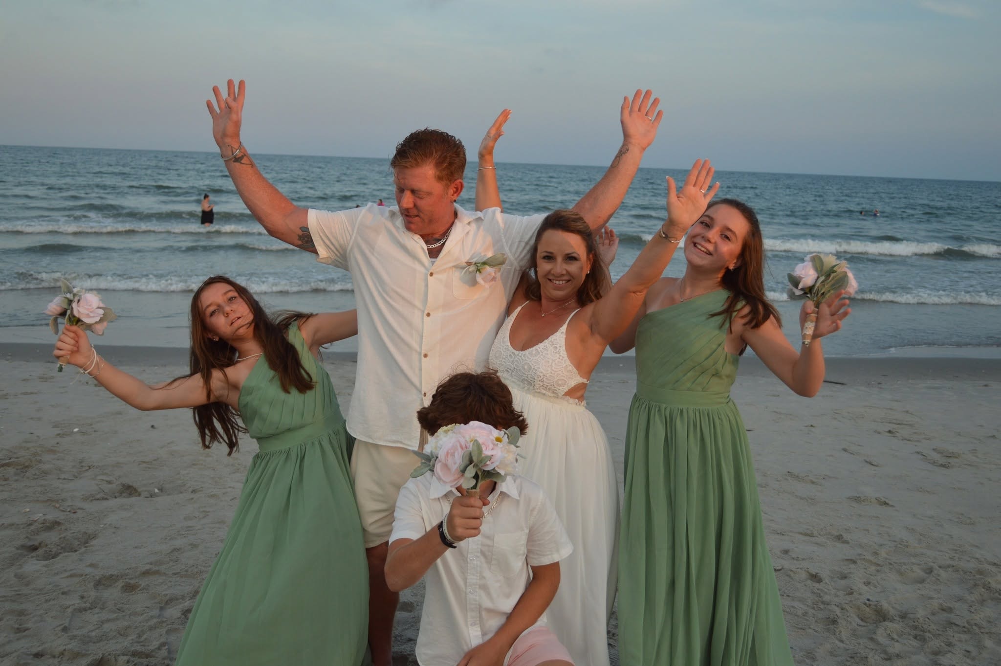 Wedding party celebrating on the beach