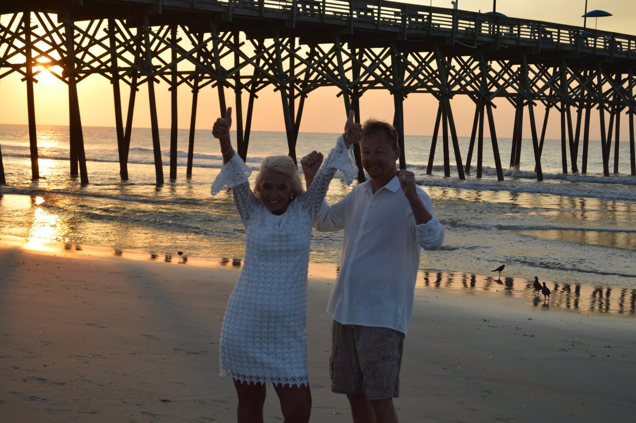Couple at sunset under the pier