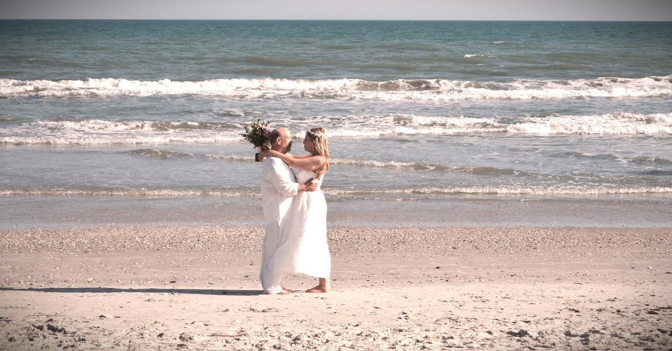 Couple dancing on beach waves